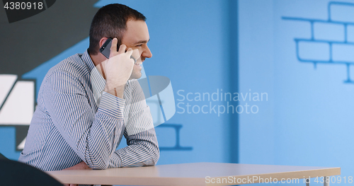 Image of Senior businessman  using cell phone at  stratup office