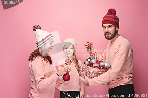 Image of Father and mother give gifts to little daughter at studio