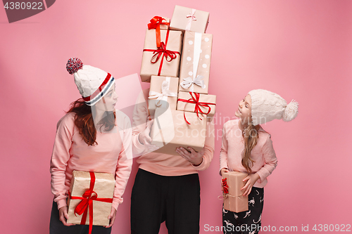 Image of Father and mother give gifts to little daughter at studio