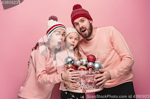 Image of Father and mother give gifts to little daughter at studio