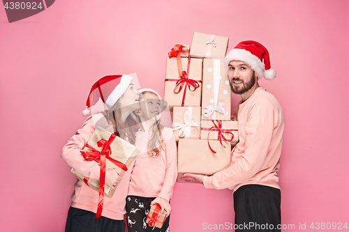 Image of Father and mother give gifts to little daughter at studio