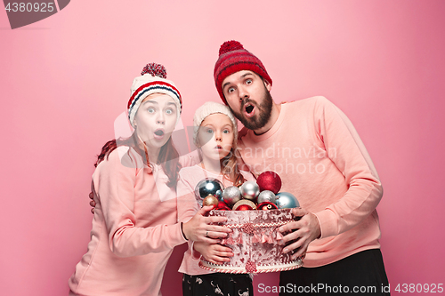 Image of Father and mother give gifts to little daughter at studio