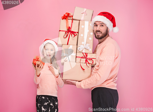 Image of Father and mother give gifts to little daughter at studio