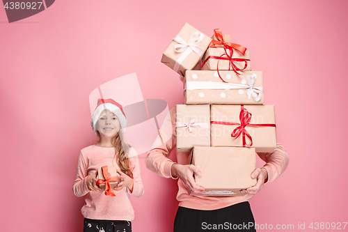 Image of Portrait of a surprised little girl with her father holding a Christmas present