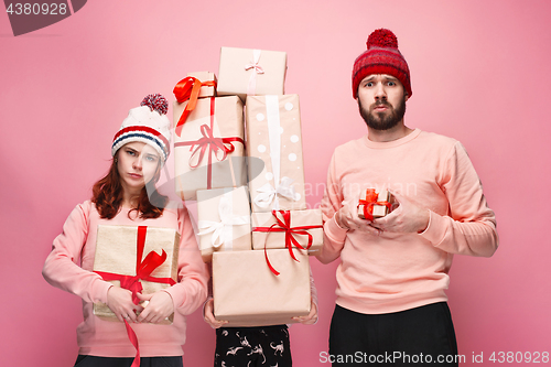 Image of Father and mother give gifts to little daughter at studio