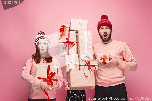 Image of Father and mother give gifts to little daughter at studio