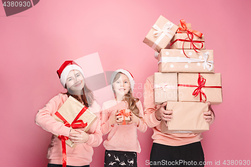 Image of Father and mother give gifts to little daughter at studio