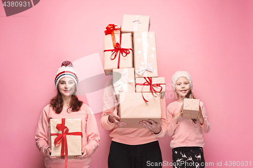 Image of Father and mother give gifts to little daughter at studio