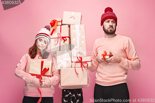 Image of Father and mother give gifts to little daughter at studio