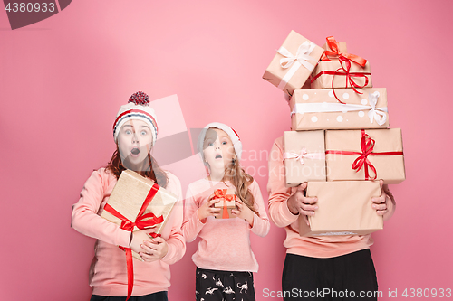 Image of Father and mother give gifts to little daughter at studio