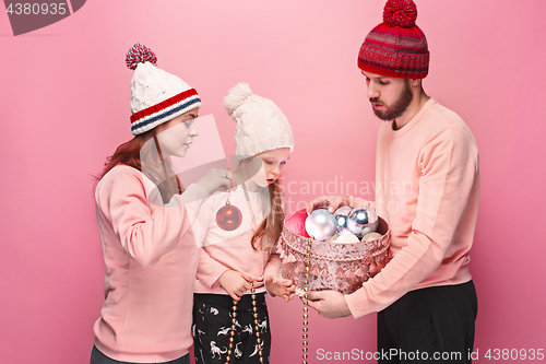 Image of Father and mother give gifts to little daughter at studio