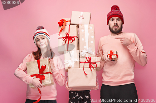 Image of Father and mother give gifts to little daughter at studio