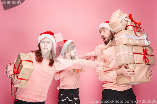 Image of Father and mother give gifts to little daughter at studio