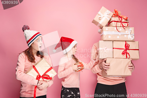 Image of Father and mother give gifts to little daughter at studio