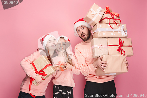 Image of Father and mother give gifts to little daughter at studio