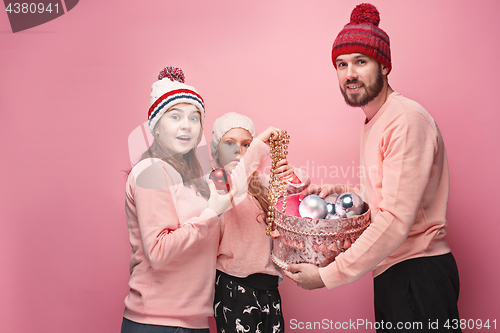 Image of Father and mother give gifts to little daughter at studio