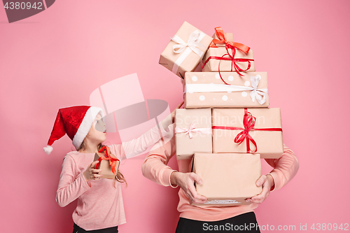 Image of Portrait of a surprised little girl with her father holding a Christmas present