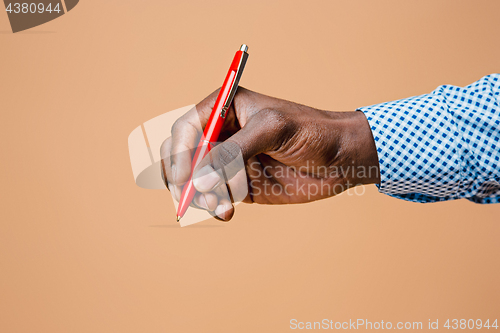 Image of Male hand holding pencil, isolated