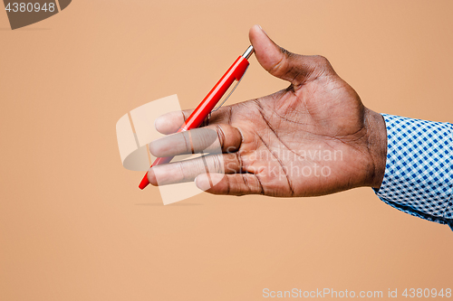 Image of Male hand holding pencil, isolated