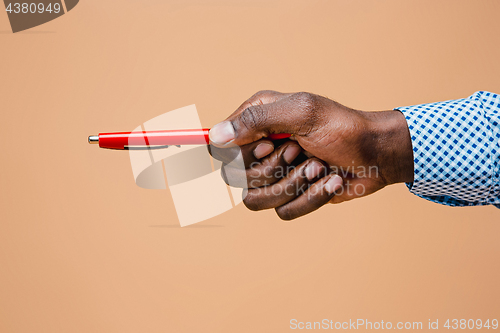 Image of Male hand holding pencil, isolated