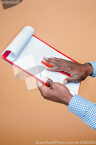 Image of Male hand holding pen, isolated