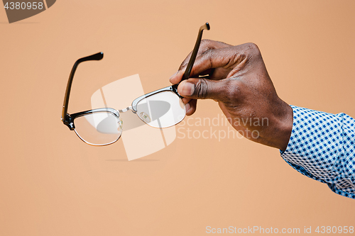 Image of Male hand holding glasses, isolated