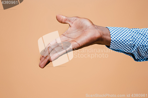 Image of Handshake. Hands of businessman isolated on brown background