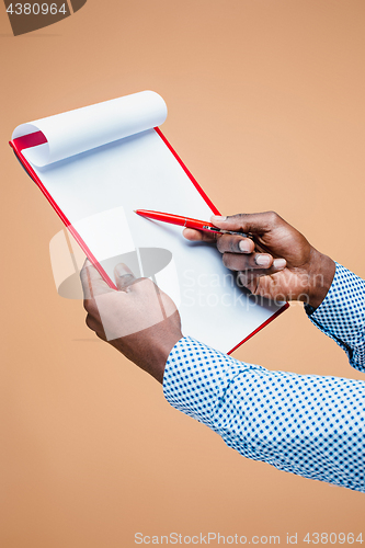 Image of Male hand holding pen, isolated