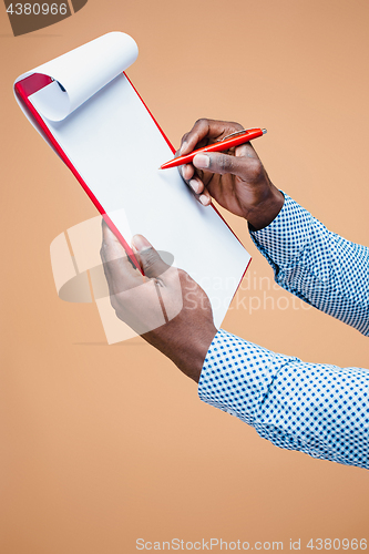 Image of Male hand holding pen, isolated