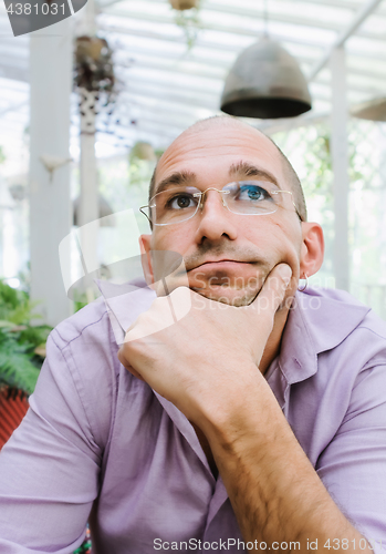 Image of Attractive Pensive Bald Man Wearing Glasses