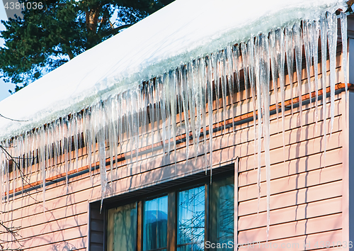 Image of Icicles And Snow On The Roof