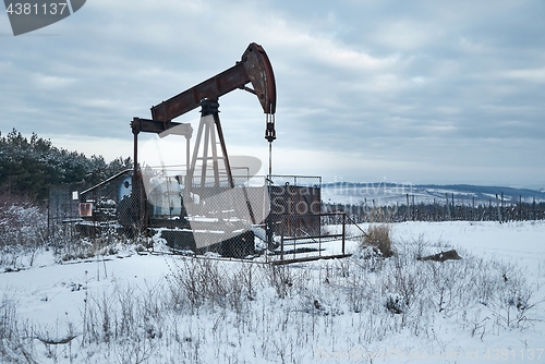 Image of Oil well on a winter landscape