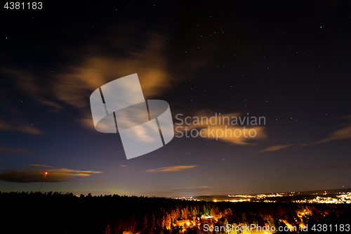 Image of A city and a forest under the sky with stars. Sweden