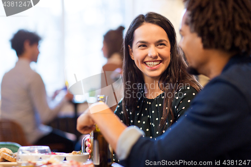 Image of happy couple with drinks at restaurant or bar