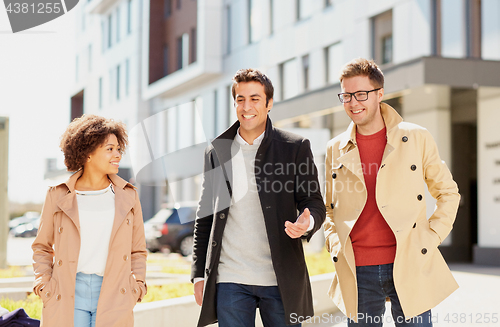 Image of office workers or friends talking on city street