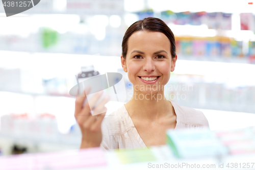 Image of female customer choosing drugs at pharmacy