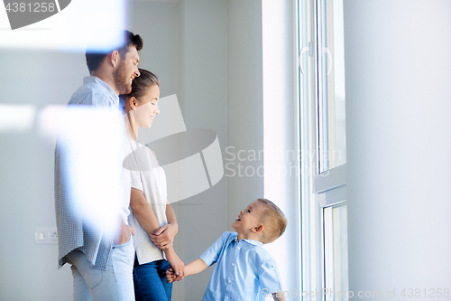 Image of happy family with child at new home or apartment