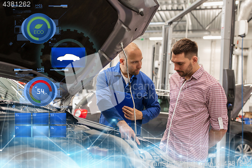 Image of auto mechanic with clipboard and man at car shop