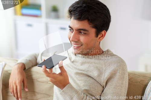 Image of man using voice command recorder on smartphone