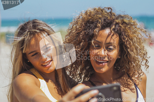 Image of Excited sportswomen taking selfie in sunshine
