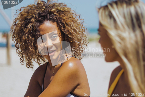 Image of Beautiful women chatting on beach