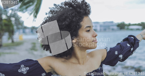 Image of Relaxing black woman enjoying fresh wind 