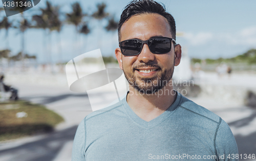 Image of Casual young man in sunglasses