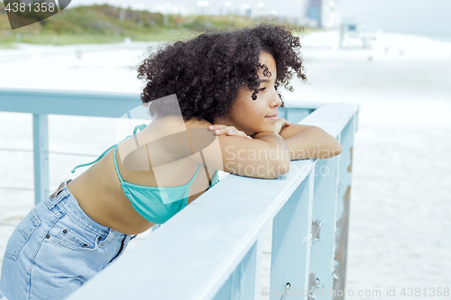 Image of Pretty black girl enjoying view on beach