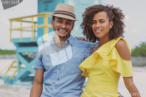 Image of Cheerful ethnic couple looking at camera