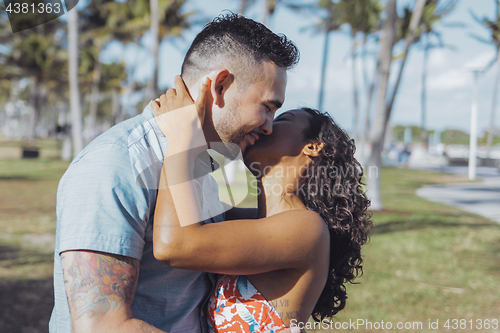 Image of Amorous kissing couple in bright sunshine
