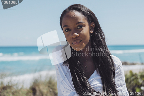 Image of Attractive young black woman looking at camera in park