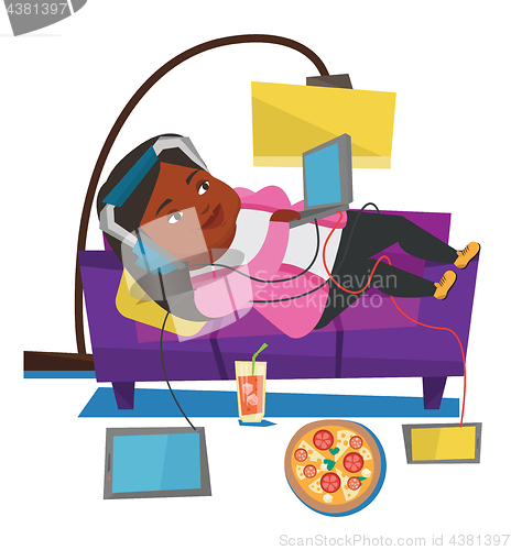 Image of Woman lying on sofa with many gadgets.