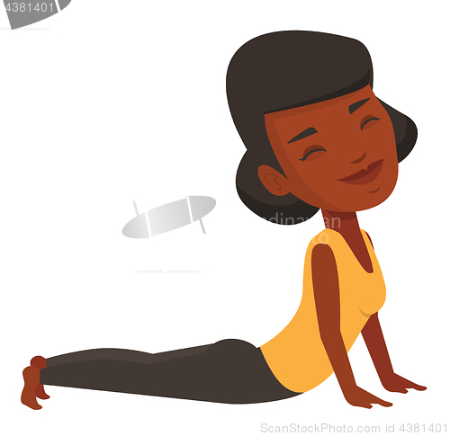 Image of Woman practicing yoga upward dog pose.