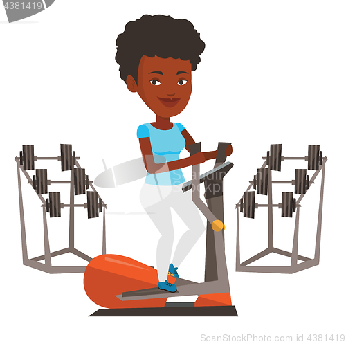 Image of Woman exercising on elliptical trainer.